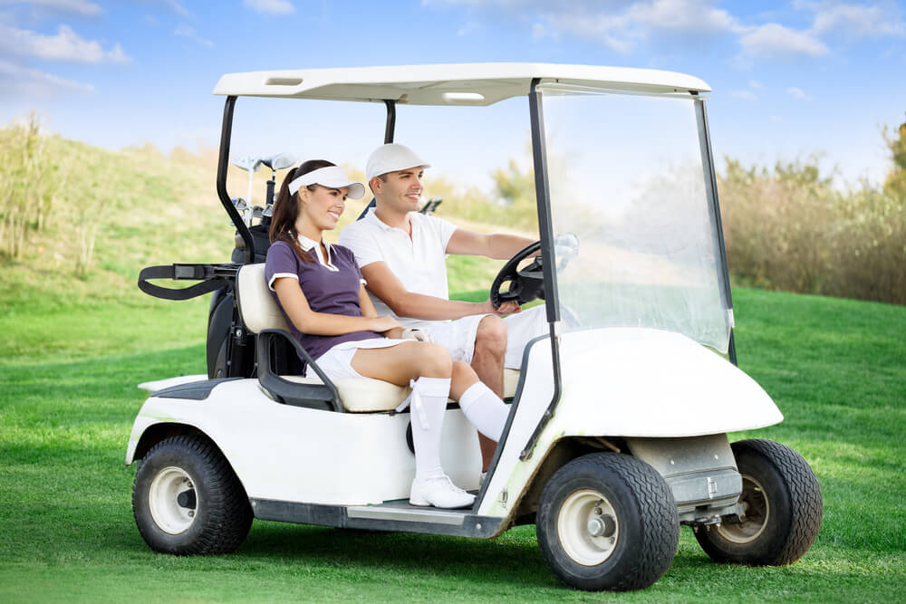 Couple riding the golf cart.