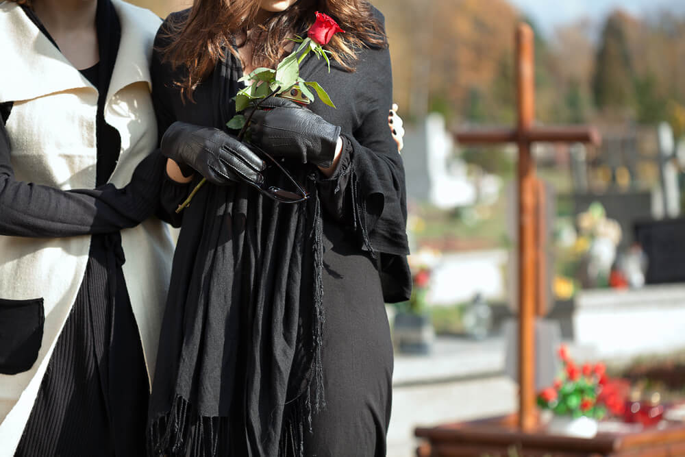 Sisters at the funeral on the death of their late mother.