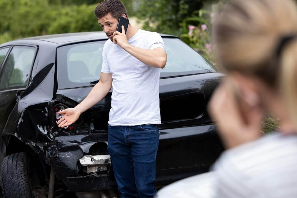 Driver calling police to report car accident.